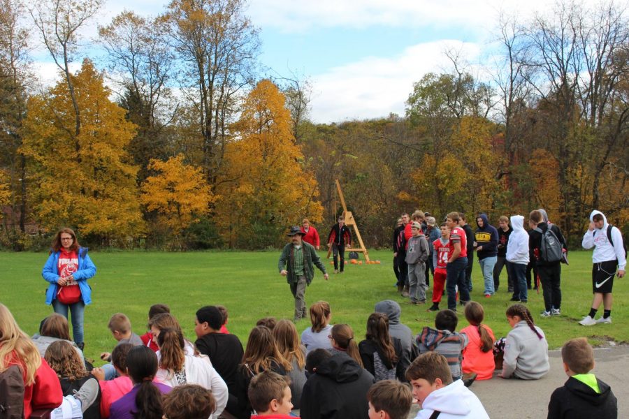 Ging explains the trebucket while the FHS Physics Club, with adviser Brian Wargo, prepares to launch pumpkins. Photo By Logan Bickerstaff