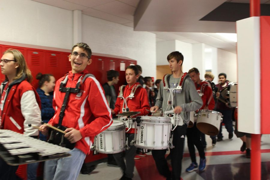 Members of the Freedom Big Red Marching Band accompany the football and soccer players during the Pep Parade through Freedom Middle School on Nov. 2.