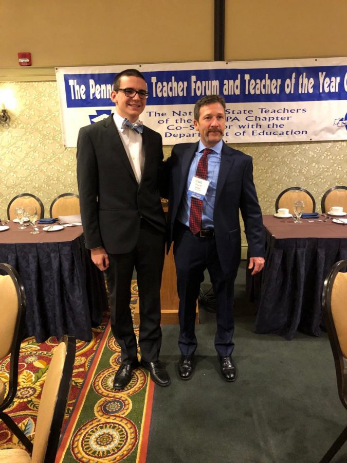 Junior Cole Skuse accompanied Wargo to the conference in Harrisburg. Above, the two are shown posing for a photo in front of photo in front of a banner that reads The Pennsylvania Forum and Teacher of the Year Celebration.
