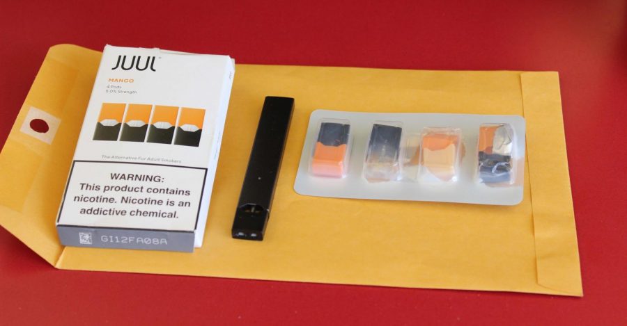 A Juul device and mango flavored pods are shown above.  Juuls are illegal to purchase if under 18, but vaping has become an increased problem in schools.