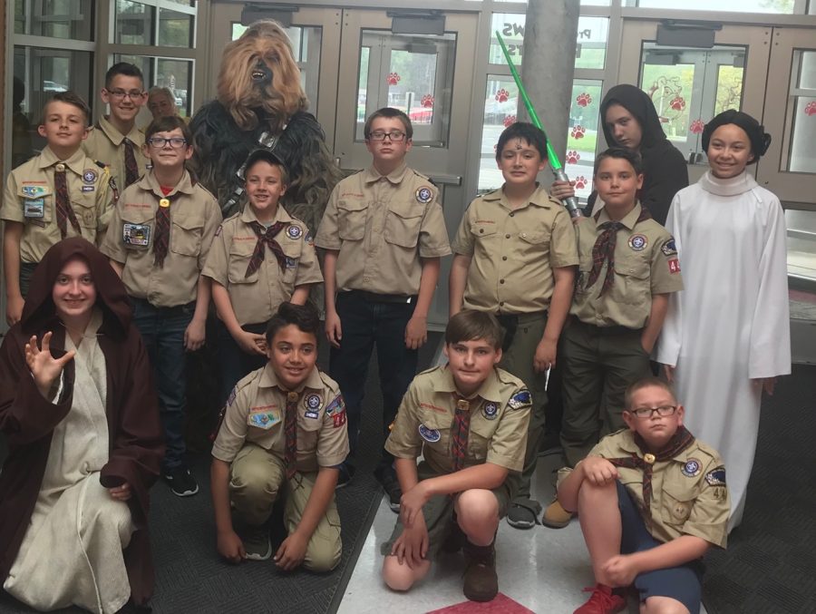 The new Boy Scouts pose for a picture with Star Wars characters in the Freedom Middle School lobby at the Blue and Gold Banquet on May 4.
