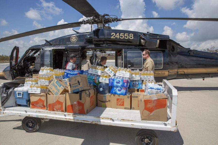 : Customs and Border Protection agents deliver food and water to severely damaged Fox Town on the Abaco Islands in the Bahamas, in the aftermath of Hurricane Dorian on Sept. 6 2019.

