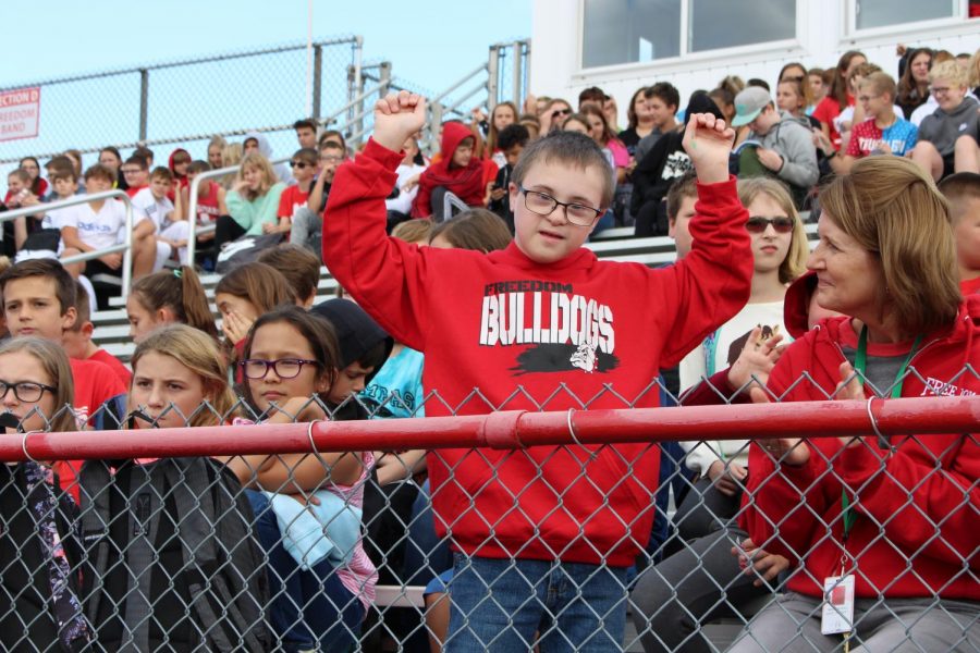 Cayden Signorelli, sixth grader, cheers on the athletes at the fall sports assembly on Oct 4. 