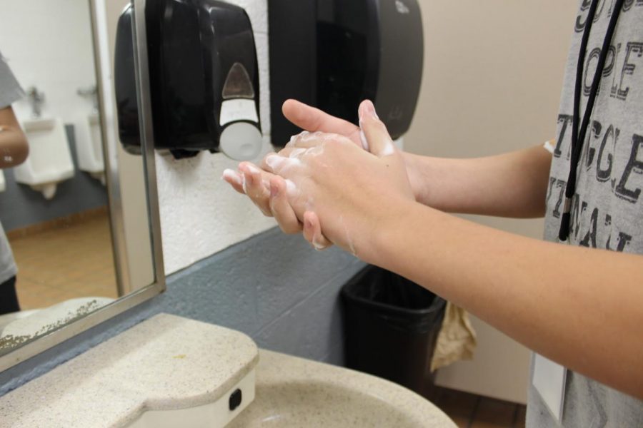 Christopher Denkovich, seventh grader, practices proper handwashing techniques inside 5th and 6th grade restroom on Feb. 26, 2020.