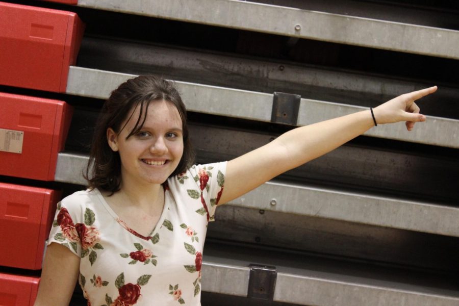 Annie Martin, sixth grade, posing in front of the gymnasium bleachers. She is alone to represent how many people don’t go to school dances.
