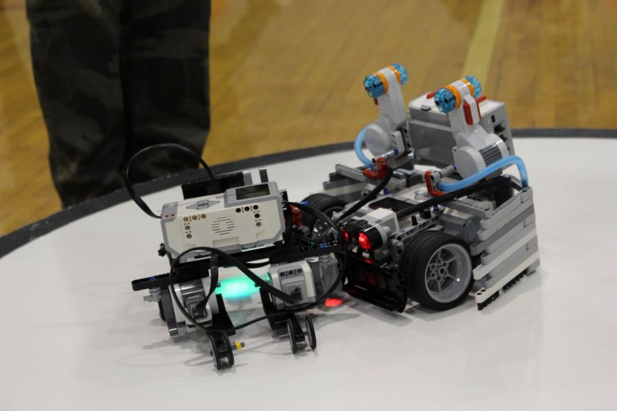 The robot of Logan Larrick and Beau Dethomas, pushes another  schools robot