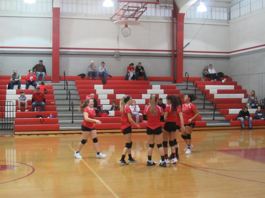 Eighth grade volleyball team warm up before their game.