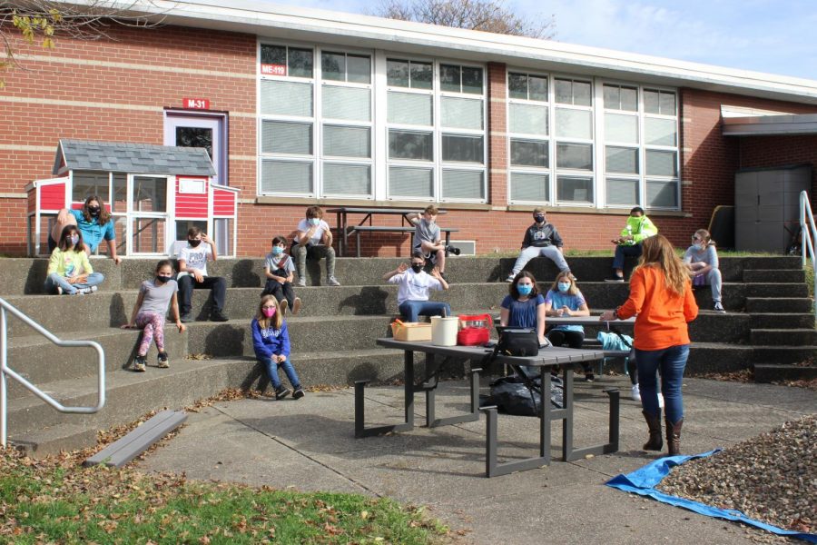 Mrs. Gings sixth grade honors math class carves, guts, and counts seeds while socially distanced in the courtyard classroom. 