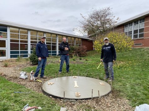 Workers from JB Concrete pour a cement pad in the shape of a compass in the courtyard classroom on Oct. 26. Heisler’s telescope can be used from this spot so that students can learn about space. 