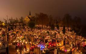Graves are decorated with candles and colors in celebration of All Souls Day. 