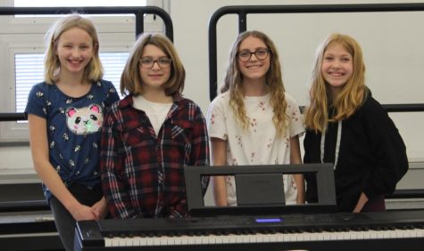 Olivia Mason, Charlotte Rywolt, Cameron Stumpf, and Caroline Bender, sixth graders, pose for chorus fest practice on Friday, March 11.
