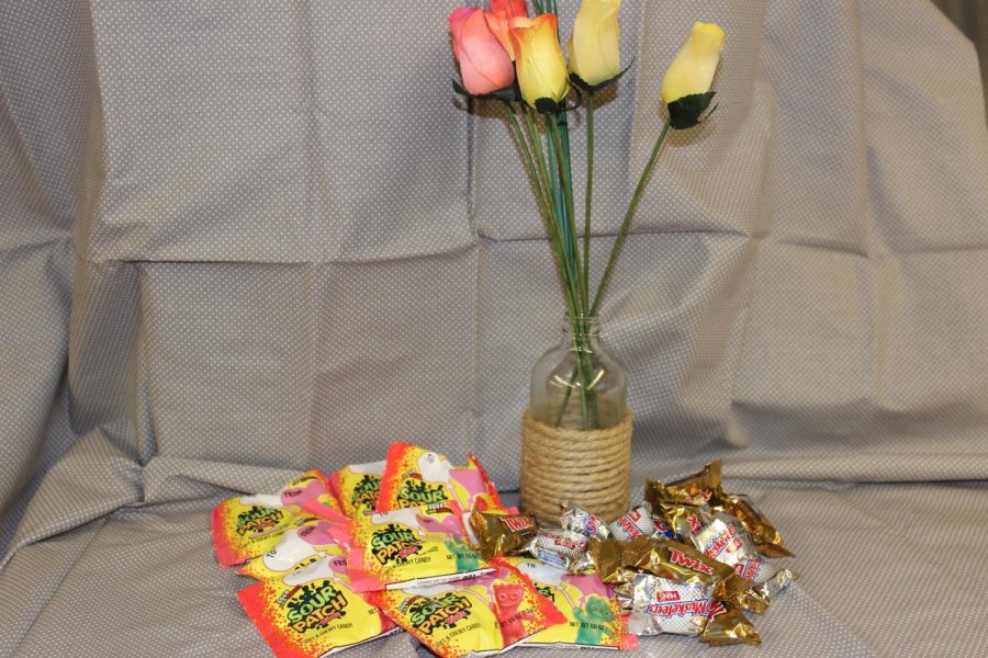Candy and flowers to symbolize the gifts that people buy as gifts for Valentines Day.
