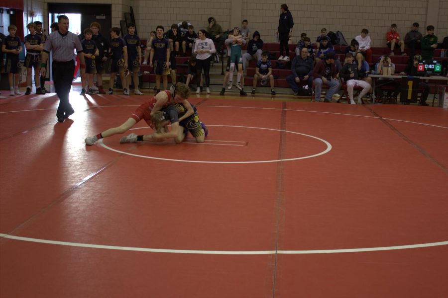 Seventh grader, Riley Henley, fights for the takedown 
          at the MAC wrestling tournament.
