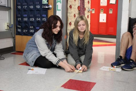 Leah Ratliff and Holly Molter, sixth graders, test their catapults made out of popsicle sticks and rubber bands in Mrs. Spencer’s room during Fall Fest. 
