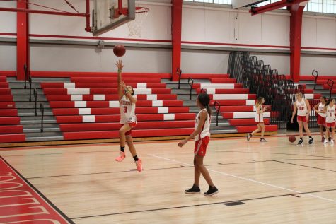 Jaylyn Gaiton shoots a layup as teammate Gracy Specht waits for the rebound in practice before the game on Nov. 17.