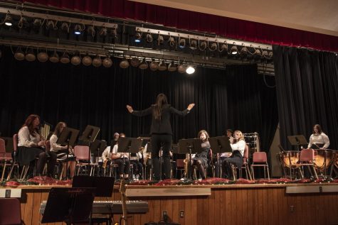 Ms. Emily Rickard, band director, conducting the seventh and eighth grade band at the winter band concert on Dec. 13 in the Freedom High School auditorium.