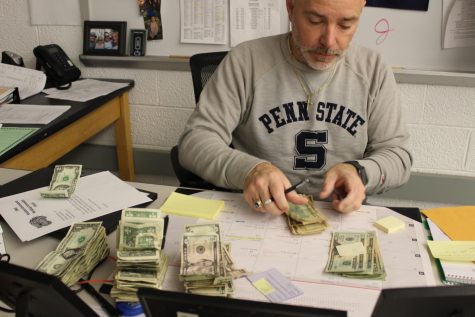 Mr. Culler counts dollar bills in his room on Dec. 13, 2022.