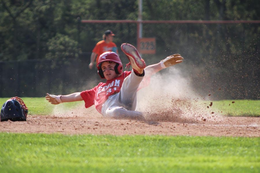 Nick Fessler slides into home plate in Wednesday's game at Beaver Falls.