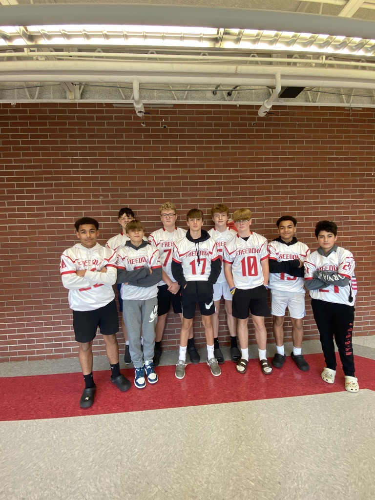 Junior high football team poses in their jerseys for group day  sponsored by the Pep Club during homecoming spirit week
