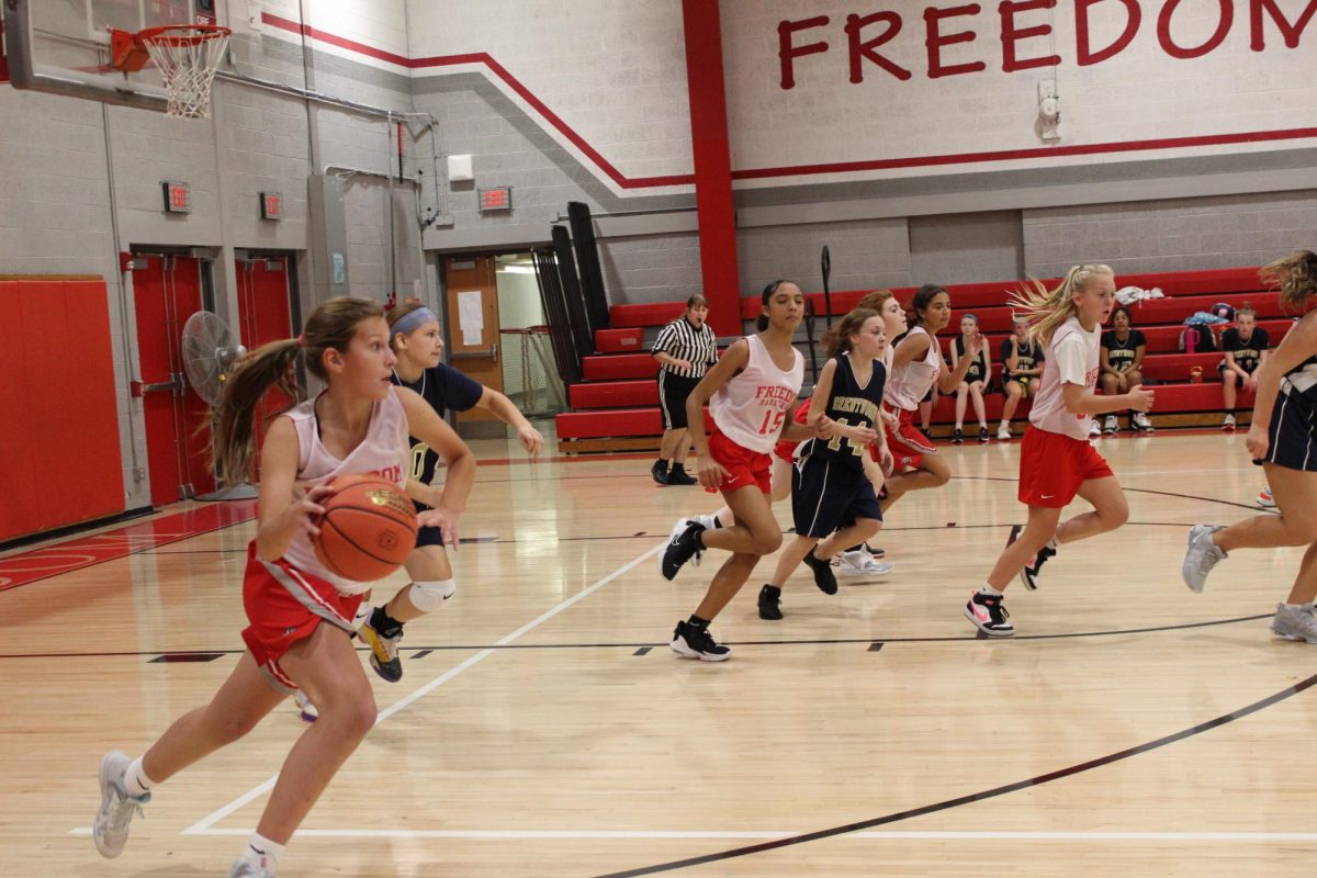 Freedom+girls+basketball+player%2C+Kaitlin+Evans%2C+takes+the+ball+down+the+court+to+score+a+basket+on+Oct.+24+at+the+Freedom+Area+gymnasium.%0A