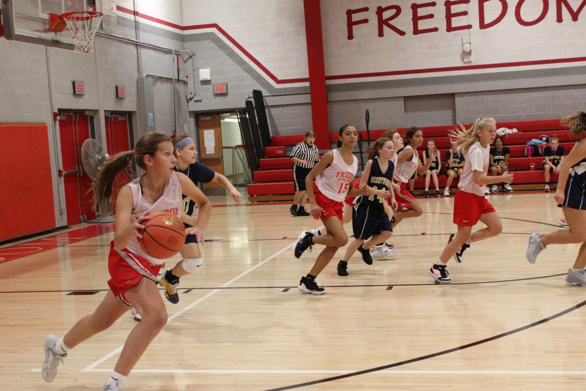 Freedom girls basketball player, Kaitlin Evans, takes the ball down the court to score a basket on Oct. 24 at the Freedom Area gymnasium.
