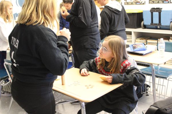 Lucy Tyler and Josie Hall, fifth graders, count pennies together for the penny drive in Mr. Culler’s classroom.   