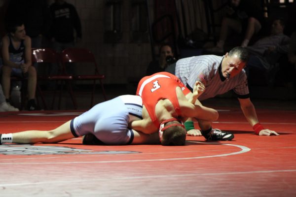  Zackery Shiring tackles an opponent at the wrestling match at home on Thursday, Jan. 18.
