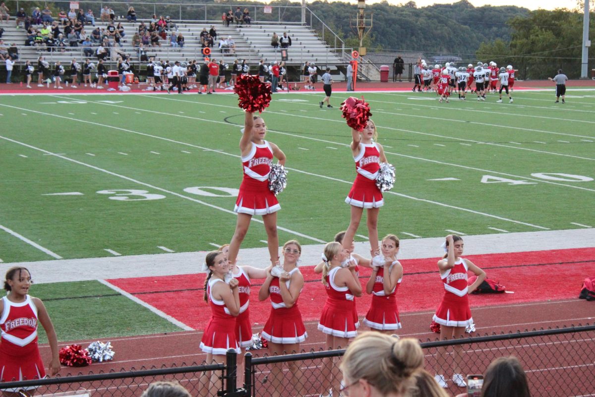 The cheerleaders cheered loud and proud for the Middle School as they got ready to make a play.