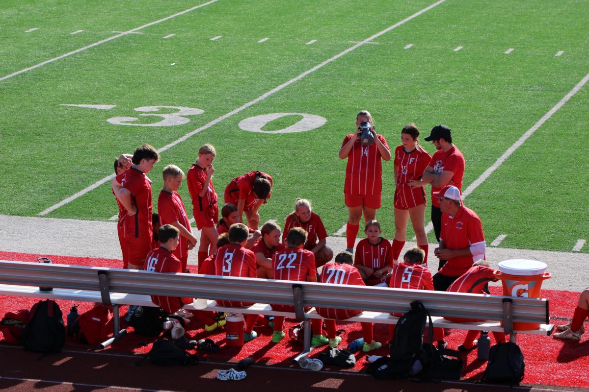 Coach Tim Casto talks to the team during halftime at a home game versus Central Valley.