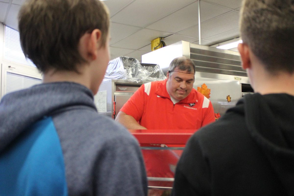 Principal Griffith serves new Thanksgiving meal to students on Nov. 21 in the cafeteria.