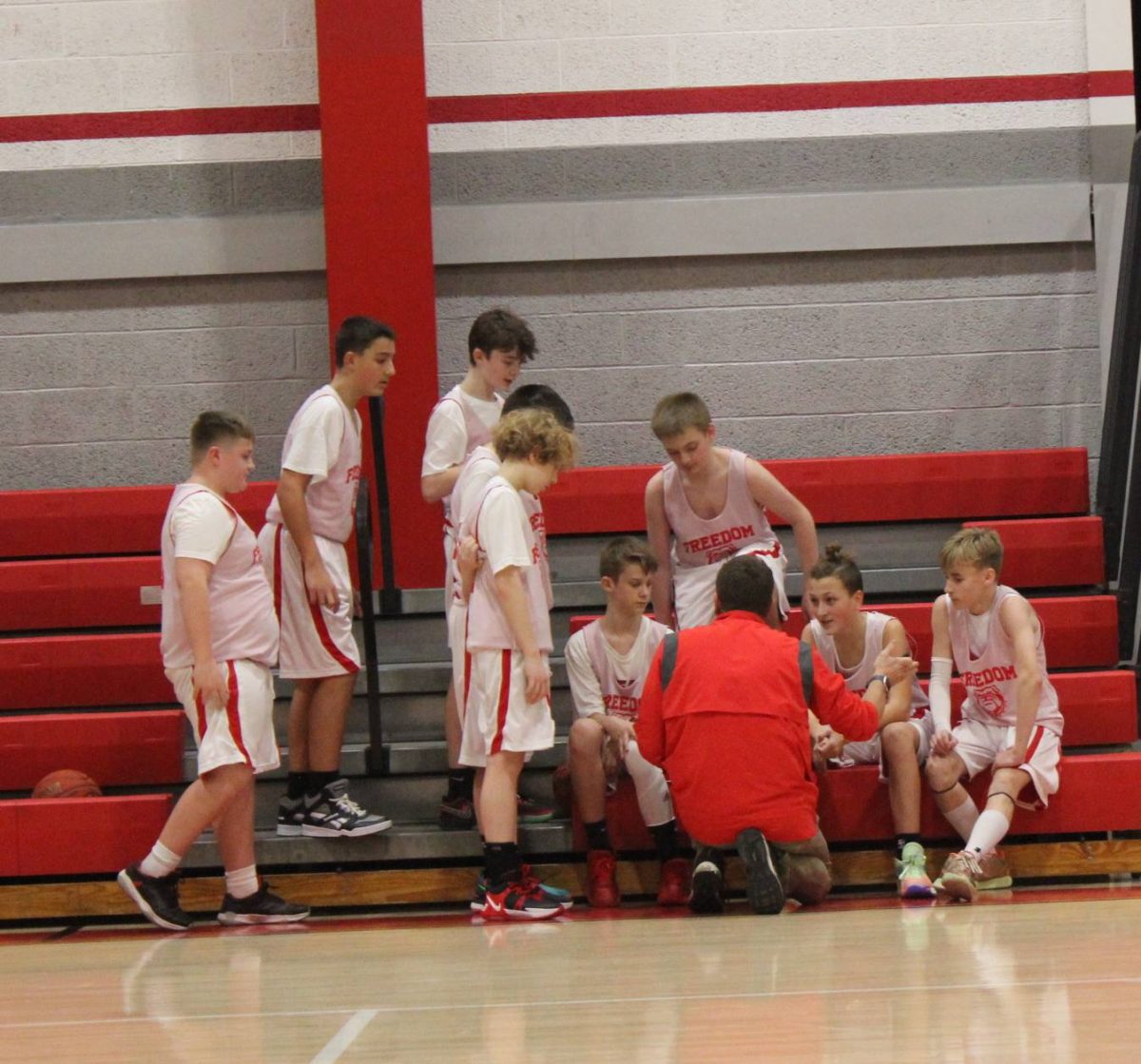 Coach Mohrbacher tells the seventh grade team what play they will be running, at the game on Dec. 10, 2024, against Burgettstown at Freedom Middle School.