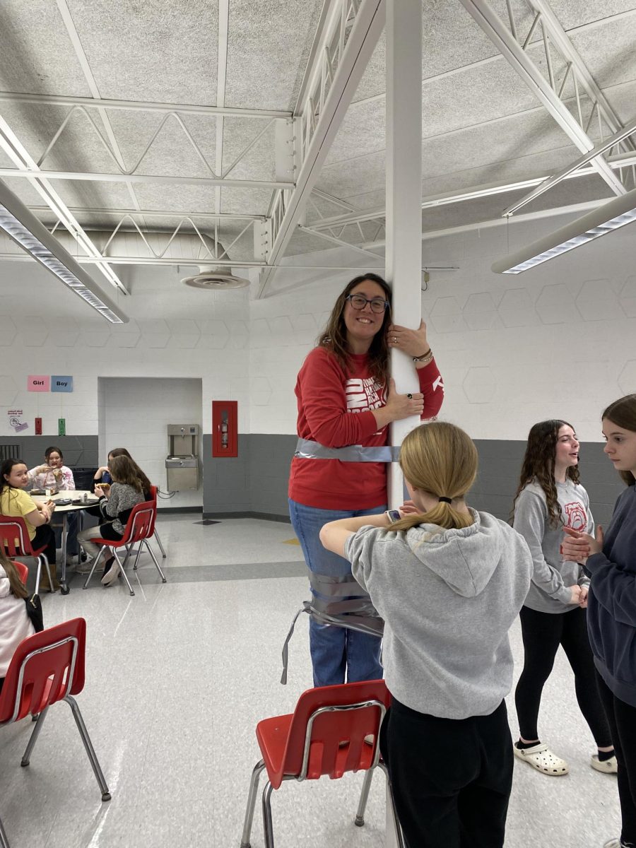 Mrs. Spencer, 6th grade ELA and Science teacher, hangs on the pole while being taped on Feb. 21.