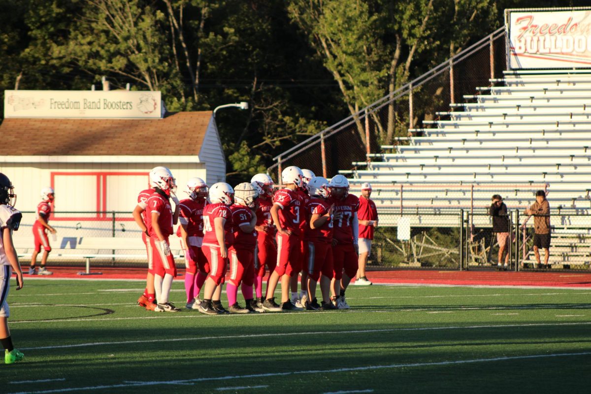 Freedom football huddle up on offense and wait for the next play.