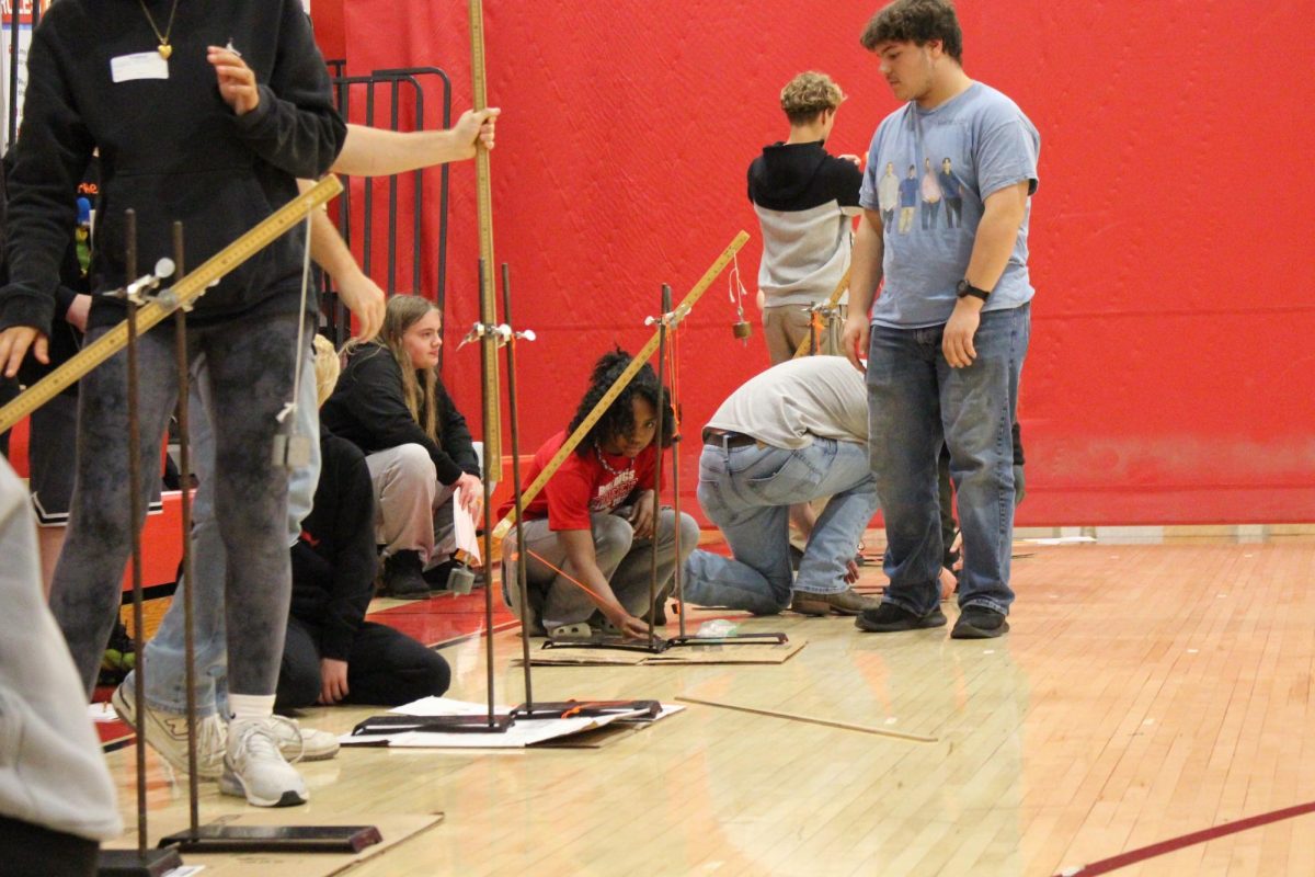 Students use the mini trebuchets in the gym.