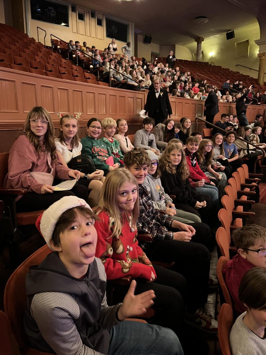 Sixth grade class in their seats, ready to watch the play.