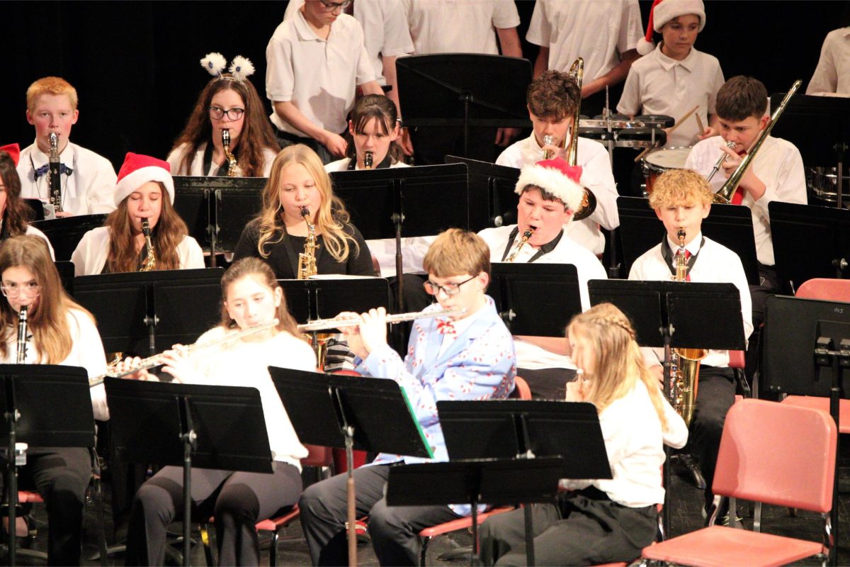 The seventh and eighth grade band performs in the high school auditorium.