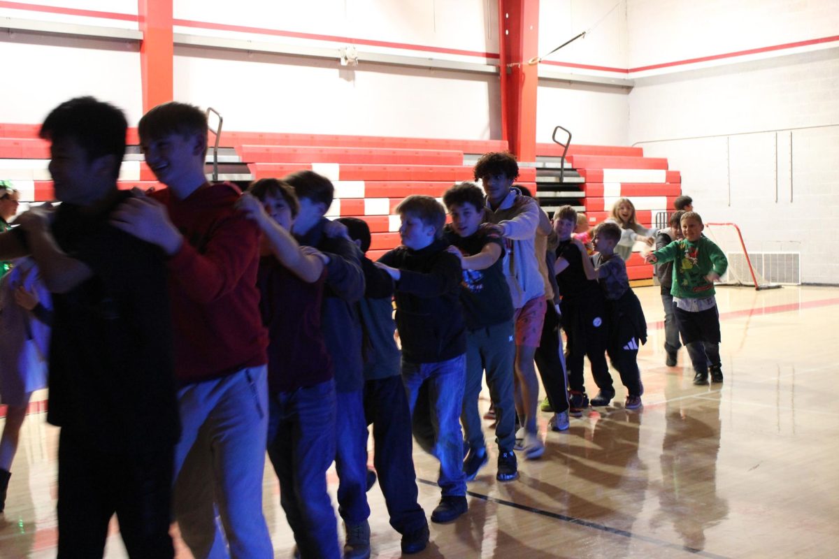 Grades 5-8 doing a dancing line at the middle school holiday dance.