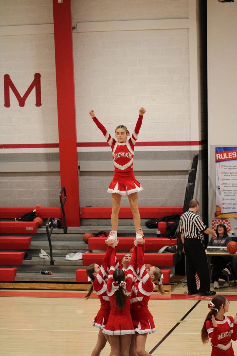 Students Alexa Straile (8), Presley Malsch (8), Temperance Max (8), and Gianna Castronovo (7) do a stunt during an 8th grade home game at halftime on Nov. 17, 2025.