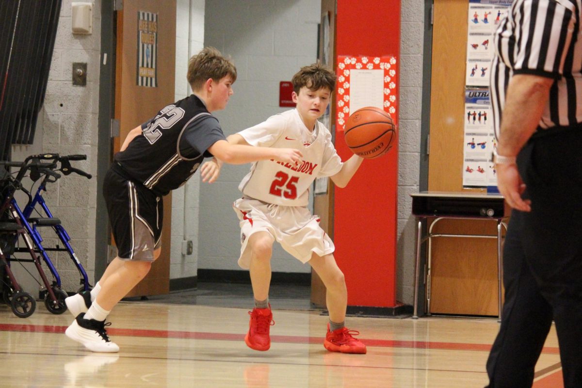 Kamden Kuntz (7) tries to pass the ball while being defended by a South Side player at home on Jan. 12.