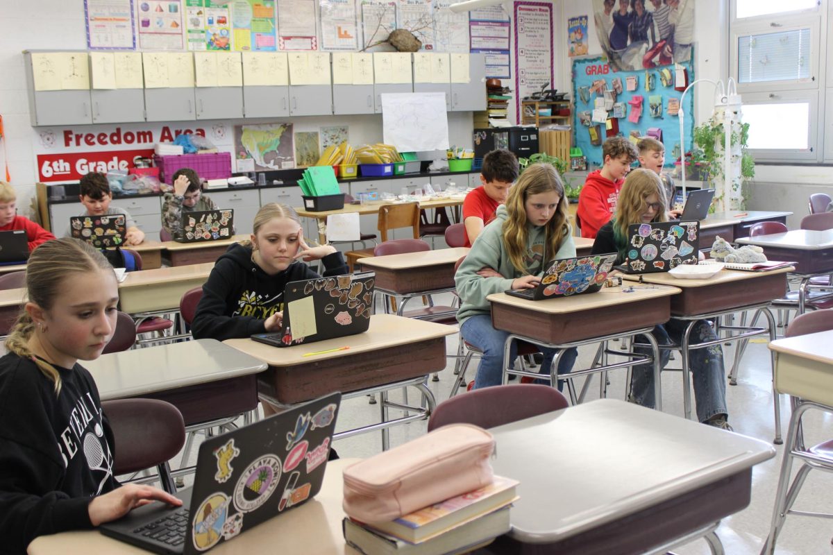 Sixth grade students during 9th period focus on their computers.