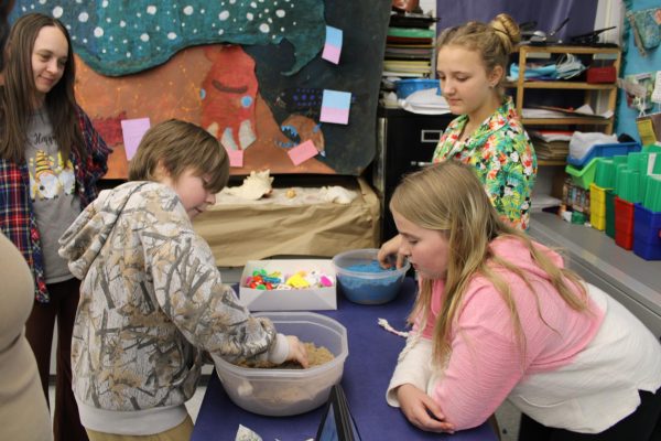 Madison Vaughan (6) and Arya Carney (6) teach kids about the sea floor.